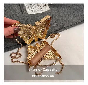Detail show of golden butterfly mini evening bag with rhinestone texture and chain