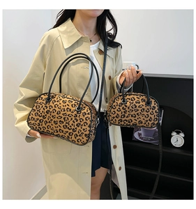 Lifestyle shot of leopard print handbag set featuring a large tote and a crossbody pouch