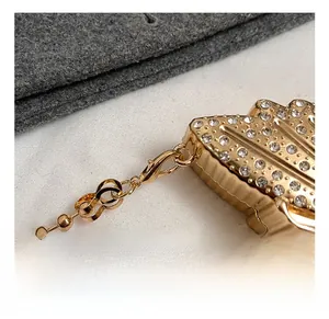 Detailed close-up of high-quality metal hook and rhinestone pendant on the bag