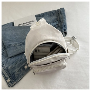 Detailed view of white nylon chest bag main compartment fitting a phone and long wallet