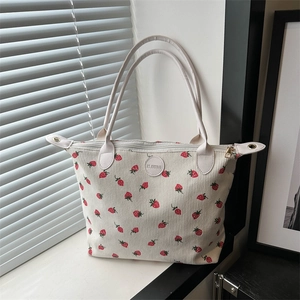 White corduroy tote bag with strawberry print and shoulder straps for daily use