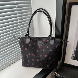 Black corduroy tote bag with red strawberry print and long leather handles for women