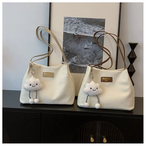 Close-up of waffle texture canvas tote bags with leather labels and cloud plush charms