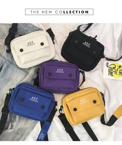 Detail view of colorful canvas crossbody bags in white, black, purple, blue and yellow