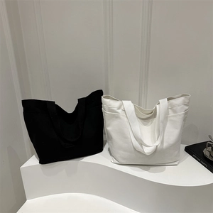 Minimalist large capacity canvas tote bags in black and white with dual shoulder straps