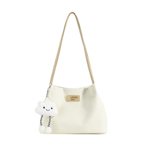 Large white corduroy tote bag with brown leather straps and a cute plush cloud charm