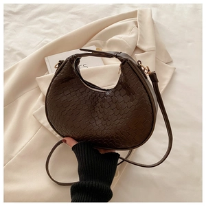Vue détaillée du sac croissant en similicuir tressé marron foncé avec détails dorés