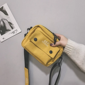 Minimalist yellow canvas crossbody bag with DCY logo and front flap for casual daily wear