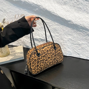 Chic leopard print handbag with black leather trim and rounded handles for urban fashion