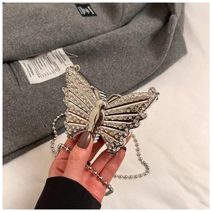 Detail view of a silver butterfly evening bag with sparkling rhinestones and bead chain