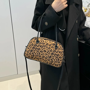 Fashionable leopard print handbag with black handles and shoulder strap for women
