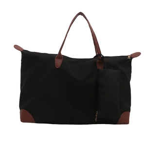 Large black nylon tote bag with brown leather handles and matching mini pouch