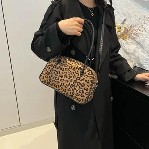 Fashionable leopard print shoulder bag for women with black straps on black coat model