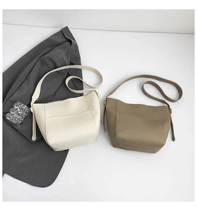 Detail of lychee pattern leather texture on minimalist hobo tote and crossbody bags