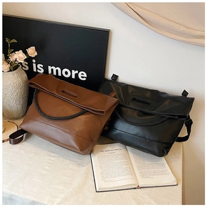 Detail of minimalist leather crossbody bags with vintage braided rope handle design