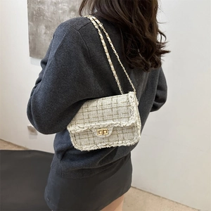 Fashionable woven tweed chain shoulder bag shown on model for size and style perspective