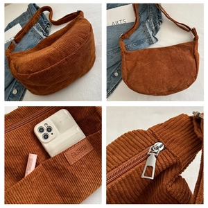 Detail view of brown corduroy crossbody bag with adjustable strap and inner pocket
