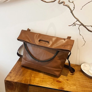 Retro brown leather tote bag with unique oval handle and woven rope accent for women