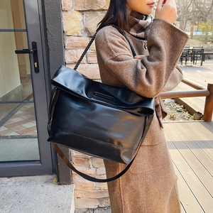 Chic black large capacity tote bag with rope straps shown on a model for winter fashion