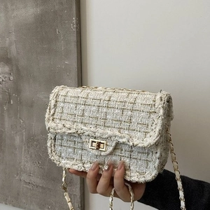 Elegant white tweed chain crossbody bag with golden metal hardware and rotary buckle