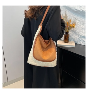 Detail of faux shearling tote bag showing soft texture and premium brown suede stitching
