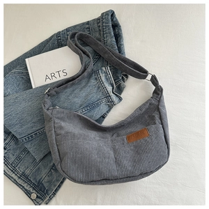 Detailed macro view of dark grey corduroy fabric with fashion leather patch on tote bag