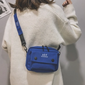 Blue canvas crossbody bag with white DCY logo and front snap pocket for women