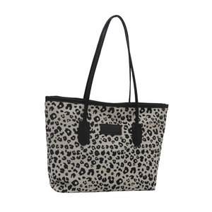 Fashionable leopard print tote bag with black handles and vintage leopard pattern