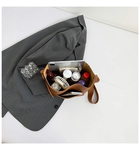 Top view of brown leather tote bag interior showing spacious capacity for iPad and water bottle