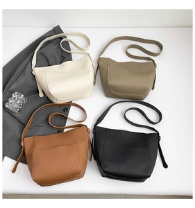 Flat lay of large capacity leather bucket bags in white, khaki, brown and black colors
