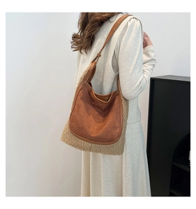 Detailed close-up of brown suede and white faux shearling patchwork hobo tote bag