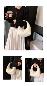 Detailed close-up of white crescent bag with elegant woven texture and geometric pattern
