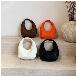 Detailed view of semi-circular hobo bags with geometric texture in four chic colors