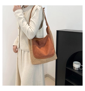 Close-up detail of a brown faux suede and beige fuzzy shearling patchwork tote bag