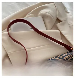 Detail of leopard print shoulder bag with red strap and golden horsebit hardware
