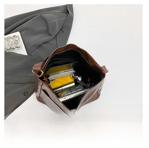 Interior view of large brown leather tote bag showing spacious storage for daily items