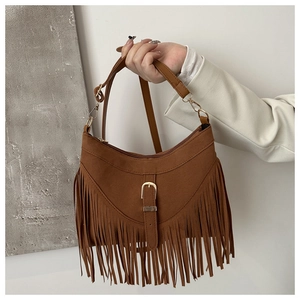 Borsa tote in camoscio marrone con frange e tracolla larga portata da una modella