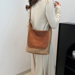 Women's fluffy sherpa tote bag with brown leather strap in a minimalist retro style