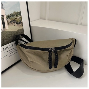 Detail of khaki crescent moon bag showing wrinkled nylon texture and black zipper cords