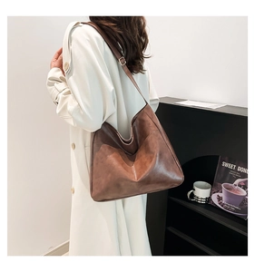Brown vintage faux leather tote bag with oil wax texture and adjustable strap detail