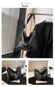Detail of black glossy PU tote bag with side pocket and wide shoulder strap