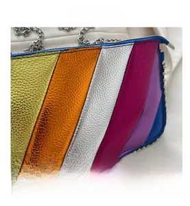 Detail showing the colorful rainbow stripe texture and silver metal chain of the handbag