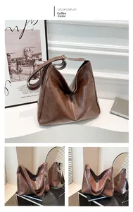 Detail of coffee brown PU leather hobo bag with adjustable strap and contrast stitching