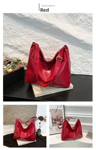 Detail view of red glossy PU leather tote bag with adjustable strap and golden buckle