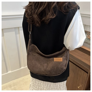 Brown corduroy crossbody bag with Fashion label shown worn as a shoulder bag