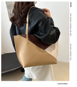 Close-up of contrast color geometric leather tote bag featuring brown and khaki patchwork