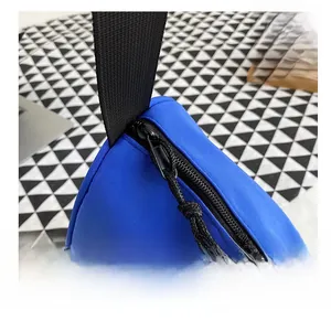 Detail showing smooth black metal zipper and durable blue nylon fabric on crossbody bag