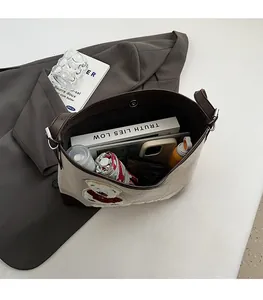 Interior view of large beige canvas tote bag showing spacious storage for daily items