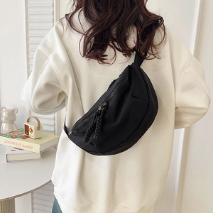 Minimalist black nylon crossbody bag for men and women in casual outdoor scene