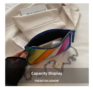 Capacity display of colorful striped crossbody bag showing phone and earphone storage